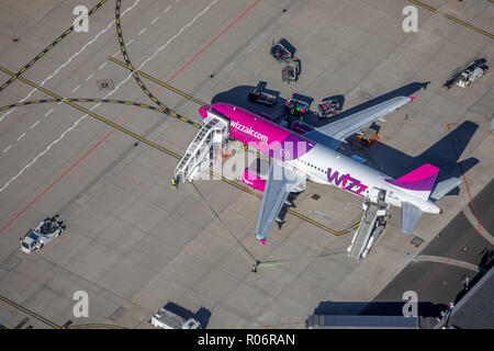 Aerial view, WIZZ-Air, travel jet at the loading position, luggage cart, Dortmund International Airport, DTM, overview of runway 06 and apron, apron,  Stock Photo