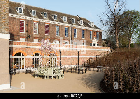 Chairs and blossoming tree on patio at Kensington Palace Stock Photo