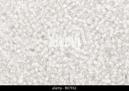 Many snow seed beads backgrouond. Glass beads texture. Stock Photo