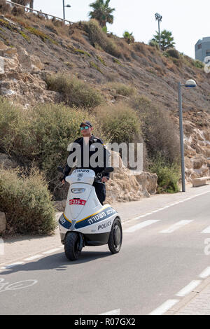 A Tel Aviv policeman on a modern 3-wheeled Segway vehicle patrolling the Jim Spitz bike path near the Mediterranean Sea Stock Photo