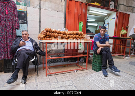 Arabic merchants in front of their bakery selling breads in the Muslim Quarter of the Old City of Jerusalem in Israel. Stock Photo