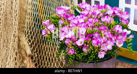 flower bouquet of pink and white alstroemeria holiday panoramic banner background and rope net Stock Photo