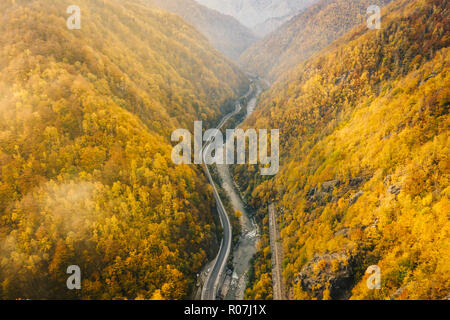 Foggy morning on the road in the canyon aerial view over Jiului Valley Stock Photo