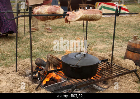 Old-style outdoor cooking over open fire Stock Photo