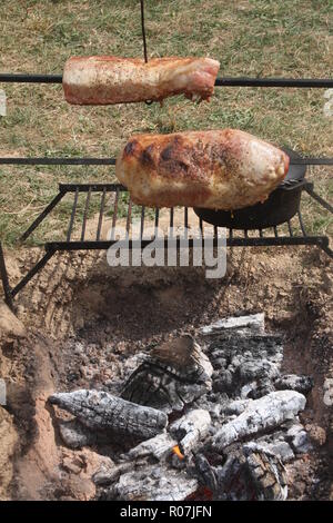 Old-style outdoors cooking over open fire Stock Photo