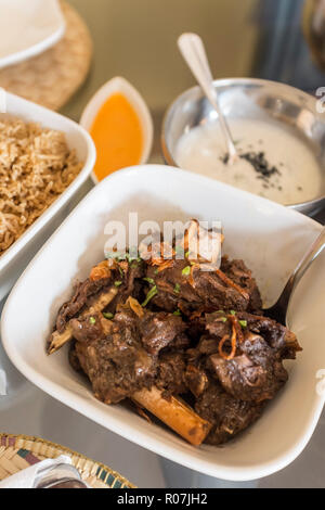 Shuwa - a traditional Omani dish where meat is marinated in spices, wrapped in palm or banana leaves and then cooked underground Stock Photo