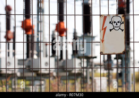 Old and  rusty Danger Keep Out High Voltage Sign on power plant entrance Stock Photo