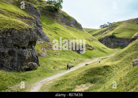 Hikers on the Limestone Way in Cave Dale, near Castleton, Derbyshire, Peak District National Park, England, UK Stock Photo