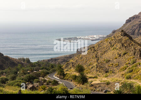 Top views of Agaete fishing town from mountain in Gran Canaria, Spain. Road leading to Puerto de las Nieves in Canary Islands Stock Photo