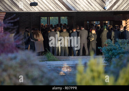 Mourners stand outside during the funeral of M40 caravan crash victim and former soldier Stuart Richards 32, at the Nuneaton Crematorium, Warwickshire. Mr Richards was killed when his vehicle was struck by a car towing a caravan travelling the wrong direction on the M40. Stock Photo