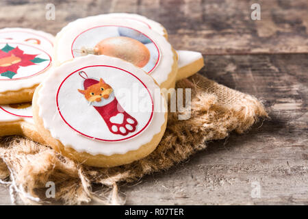 Homemade butter cookies with a printed Christmas cat design on wooden table Stock Photo