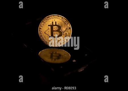 Stack of golden bitcoins isolated on black background with reflection. Cryptocurrency concept with copy space. Stock Photo