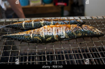 Appetizing mackerel grilled on a fest food. Steet food. Stock Photo