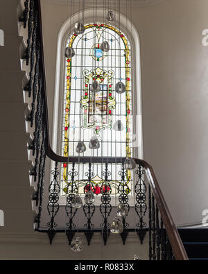 Stained glass window on staircase by pendant light Stock Photo