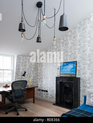 Eclectic bathroom with desk and fireplace Stock Photo