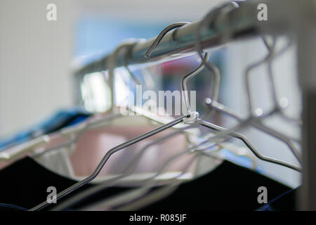 Clothes hangers on clothes rack Stock Photo