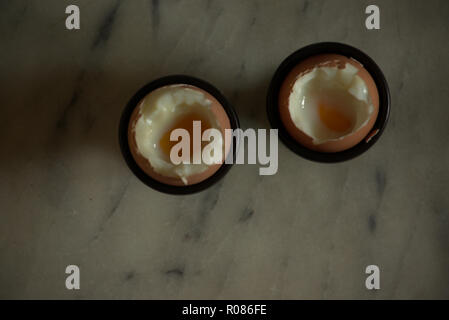 Two soft boiled eggs in egg cups Stock Photo