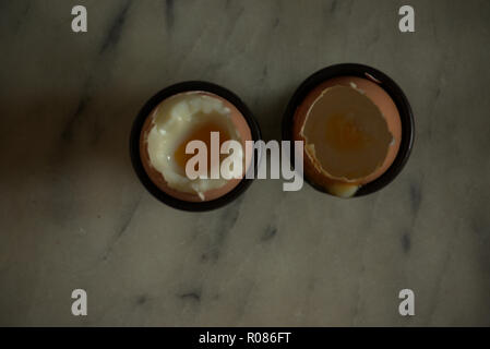 Two soft boiled eggs in egg cups Stock Photo