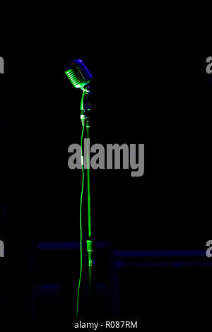 Microphone on stage with black background Stock Photo