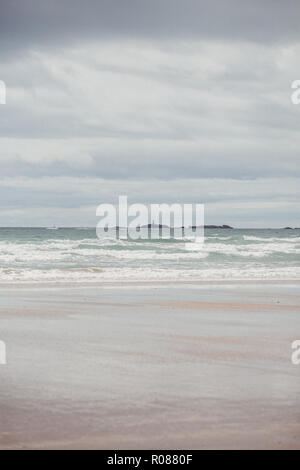 Rhoscolyn lighthouse in the distance from Cymyran beach, Rhosneigr, Anglesey, North Wales, UK Stock Photo