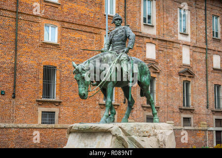 Milan, Italy - 14.08.2018: The bronze Statue of Giuseppe Missori on horse with red brick wall in background and near Piazza de Duomo in historical cen