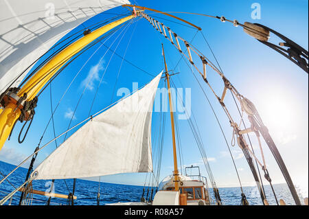 Fisheye lens view of an old schooner sails against the sun. Stock Photo