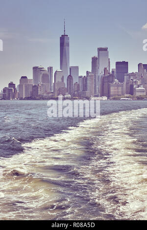 Retro toned picture of downtown New York skyline seen from a ferry, USA. Stock Photo