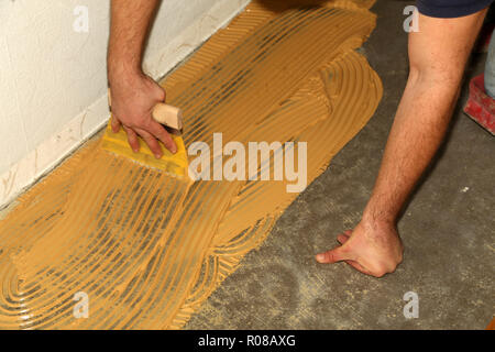 Parquet flooring. Worker laying parquet flooring Stock Photo