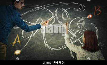 Puzzled man and woman sharing thoughts together finding the correct way from point A to point B. Solving problem idea exchange find solution. Partners Stock Photo