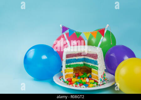 Rainbow pinata cake with candies - birthday background, card, concept - copy space Stock Photo