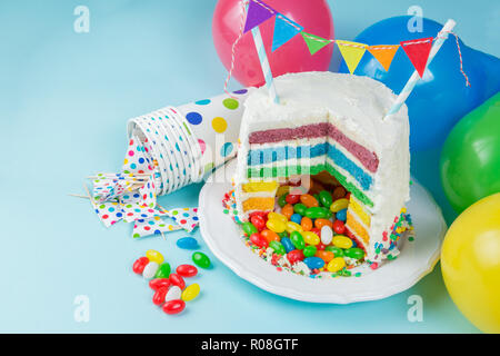 Rainbow pinata cake with candies - birthday background, card, concept - copy space Stock Photo