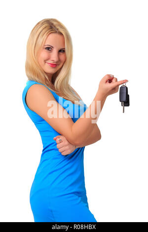 young attractive beautiful blonde girl in blue dress holds car keys on finger isolated on white background. car sale or rent concept Stock Photo