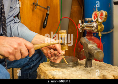 experienced Craftsman Jeweler at work in workshop Stock Photo