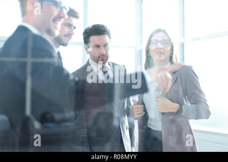 Image of a businessman's hand pointing a flowchart on the glass Stock Photo