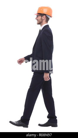 in full growth. businessman in a protective helmet, stepping forward Stock Photo