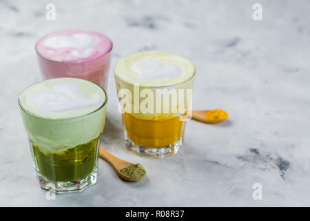 Selection of colorful super lattes matcha tea, tumeric, curcuma on marble background Stock Photo