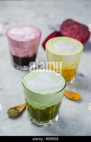 Selection of colorful super lattes matcha tea, tumeric, curcuma on marble background Stock Photo