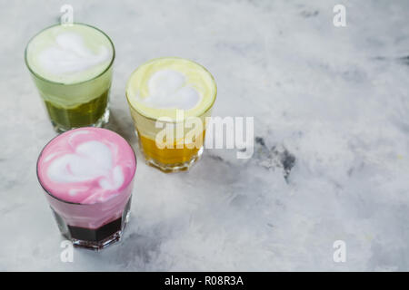 Selection of colorful super lattes matcha tea, tumeric, curcuma on marble background Stock Photo