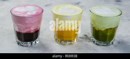 Selection of colorful super lattes matcha tea, tumeric, curcuma on marble background Stock Photo