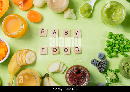Colorful baby food purees in glass jars with ingredients. Healthy organic baby food concept. Starting solid food, delivery