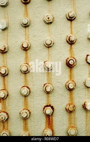 Rusting metal bolts background Stock Photo