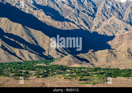 Aerial view on Matho Gompa and the surrounding village, situated above the green Indus valley, big mountains in the background Stock Photo