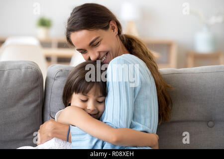Mother and daughter hugging expressing love and tenderness Stock Photo