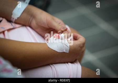 Details of a cannula on the hand of a pregnant woman in the hospital Stock Photo