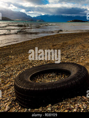 tyre trashed at beach of lake General Carrera at Puerto Rio Tranquilo, Chile, Patagonia Stock Photo