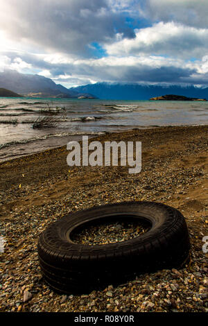 tyre trashed at beach of lake General Carrera at Puerto Rio Tranquilo, Chile, Patagonia Stock Photo