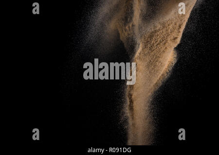 Sandy explosion isolated on black background. Abstract particles cloud. Texture element for design. Stock Photo