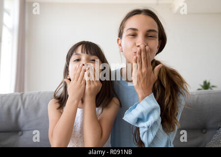 Daughter and mother have video call blowing a kiss Stock Photo