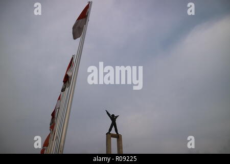 Jakarta, October 21 2018 | A statue of West Irian Liberation Monument in line of Indonesia flag at Bull's Field (Lapangan Banteng) Stock Photo