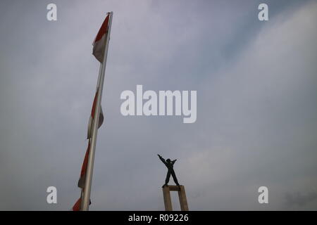Jakarta, October 21 2018 | A statue of West Irian Liberation Monument in line of Indonesia flag at Bull's Field (Lapangan Banteng) Stock Photo